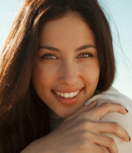 brunette woman with clear skin after hydrafacial